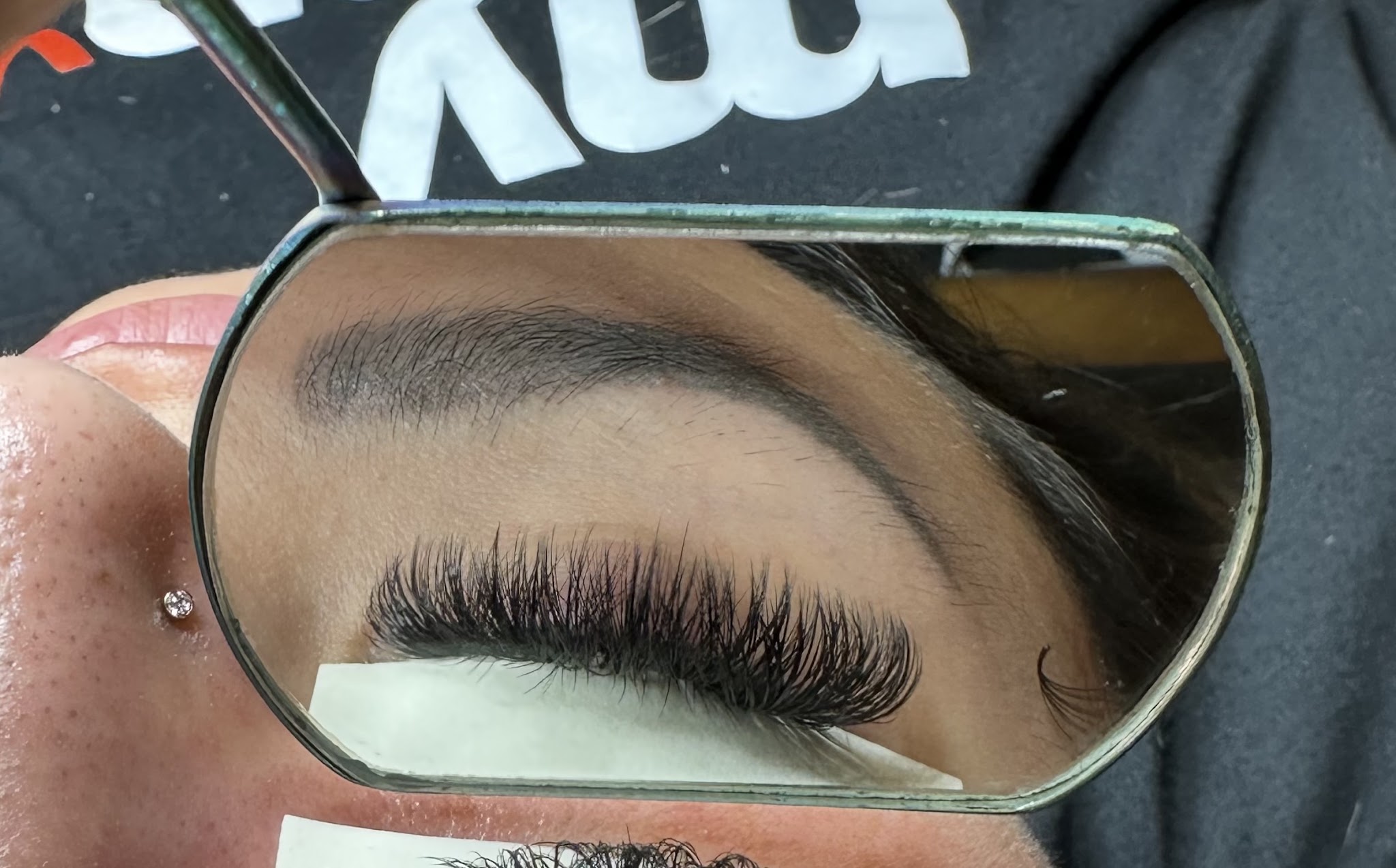 A lash set checked in the mirror
