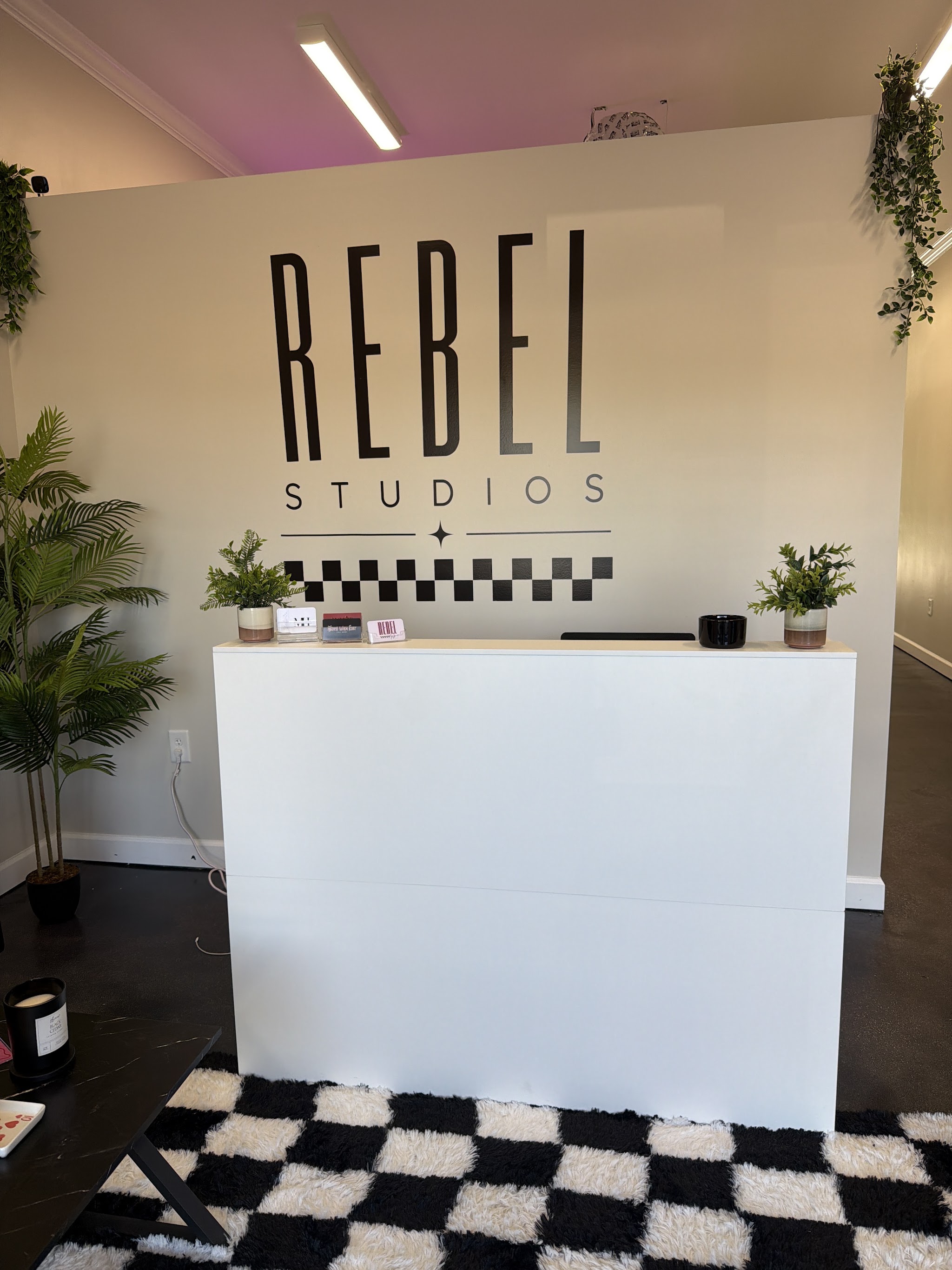 The Rebel Studios reception desk with the checkerboard rug